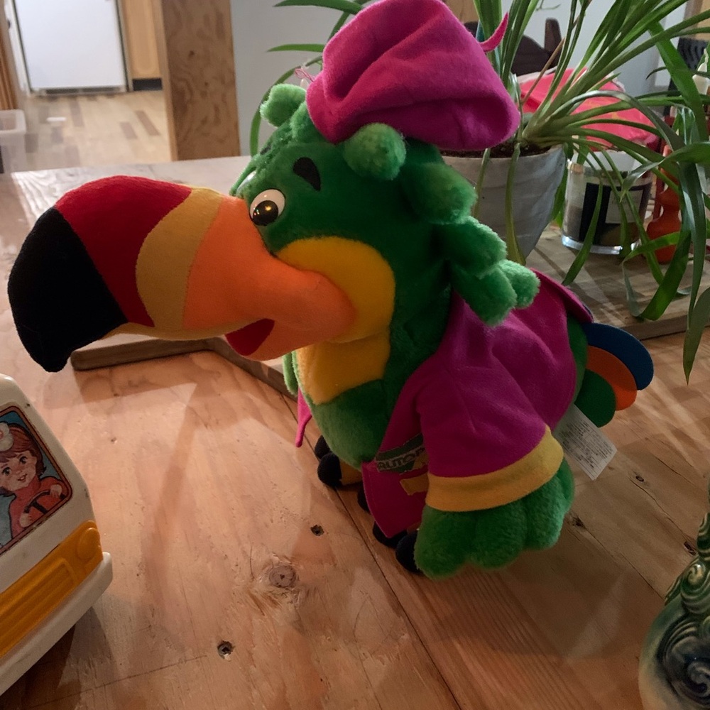 Plush Green Parrot Toy in Pink Outfit – Soft Cuddly Bird Autopro